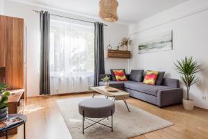 a living room with a couch and a table at Stylish City Stay in Budapest