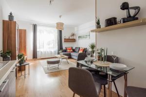 a living room with a couch and a table at Stylish City Stay in Budapest