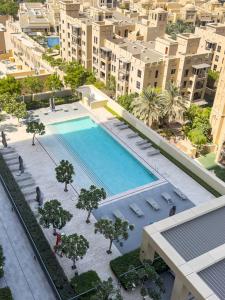 an overhead view of a swimming pool in a city at NEW 1BR in DOWNTOWN I 100m Walk to DUBAI MALL I Amazing POOL with Burj View in Dubai