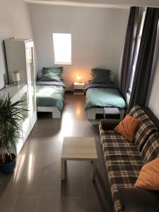 a living room with two beds and a couch at Kleve-Kellen 2 in Kleve
