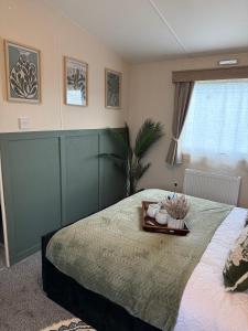 a bedroom with a bed with a tray on it at Luxury Caravan, On the beach in Redcar