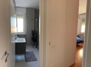 a bathroom with a sink and a toilet in a room at Alla Torre - Room & Private Bathroom in Treviso