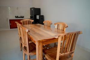 a wooden table with four chairs around it at Padma Graha Villa in Candidasa +13 photos
