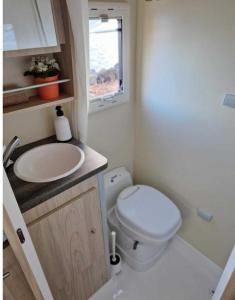 a small bathroom with a toilet and a sink at Kuaycaravans in Adeje