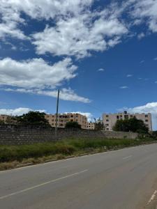 an empty road with buildings in the background and a blue sky at SaltyNest in Gatunga