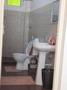a bathroom with a toilet and a sink at SaltyNest in Gatunga