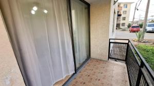 a balcony with a white curtain on a building at D14-9 Arriendo diario a pasos de la playa Arica in Arica