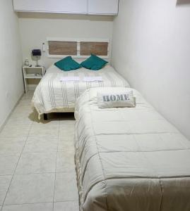 two beds in a small room with at Atenea in Chivilcoy