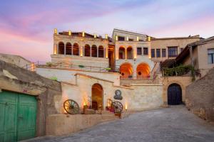 an old building with green doors in an alley at Dionysos Cave Cappadocia Hotel in Urgup