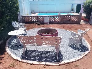 a patio with a bench and a table and a pool at Hostel La Casa de Mabel in Natal +15 photos
