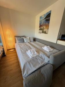 ein großes Bett in einem Zimmer mit einer Couch in der Unterkunft Fortuna 8 by Arosa Holiday in Arosa + 4 Fotos