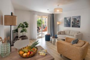 a living room with a couch and a table with a bowl of fruit at Domitys L'Ellipse in Paris