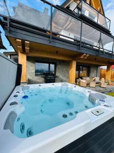 a jacuzzi tub sitting on top of a house at Tatrzański Horyzont in Biały Dunajec