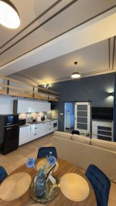 a kitchen and a living room with a table and chairs at Apartmán U Hradu in Strakonice +10 photos