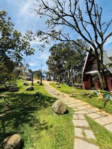 a stone path in a park with a playground at Ninans Hide Out in Santhanpara