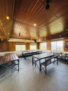 a large room with ping pong tables in it at Ninans Hide Out in Santhanpara