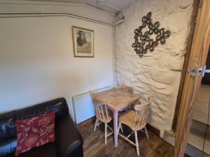 a small dining room with a table and chairs at The Old Barn in Bettws Gwerfil Goch