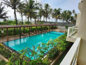 una imagen de una piscina en el balcón de un complejo en Aqua Beach Resort Apartments, en Wattala