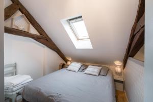 a bedroom with a bed in a attic at Ty Melaine by Cocoonr in Rennes