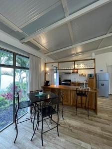 a living room with a table and a kitchen at Palco Pacífico Villa with Private Rooftop Pool in Alto del Monte