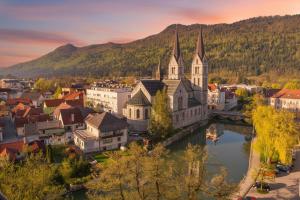 an old town with a bridge and a church at Urban NEST apartment - FREE Parking & Central in Kočevje