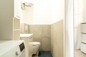 a small bathroom with a toilet and a sink at Urban NEST apartment - FREE Parking & Central in Kočevje