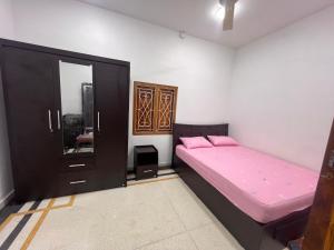 a bedroom with a bed and a mirror at DNN Brothers Villa in Jaffna +5 photos