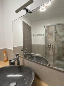 a bathroom with a large sink and a shower at Al Mulino in Schilpario