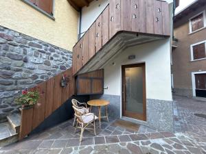 a patio with a table and chairs next to a building at Al Mulino in Schilpario