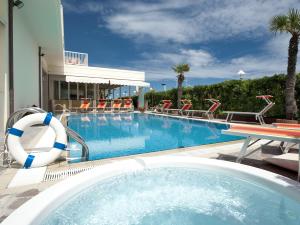 a large swimming pool with chairs and a swimming pool at Hotel Gemma in Riccione