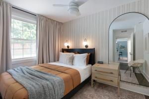 a bedroom with a large bed and a mirror at Harmony House in Nashville +53 photos