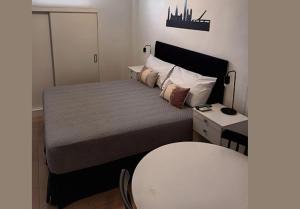 a bedroom with a bed with a table and a chair at Appart Tucuman in Buenos Aires