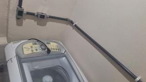 a washing machine is hooked up to a wall at Espaço inteiro in São Caetano do Sul