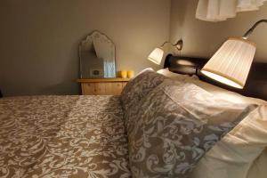 a bedroom with a bed with a lamp and a mirror at Private Boho Brampton Stay-Pets OK & Walk to GO in Brampton