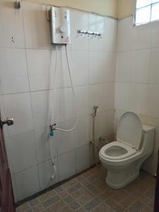 a small bathroom with a toilet and a shower at Ning Ning hostel Dondet in Don Det