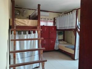 a room with two bunk beds in a house at Ning Ning hostel Dondet in Don Det