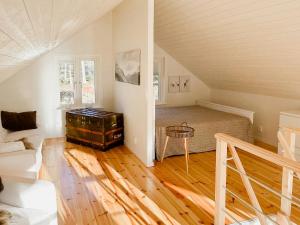a living room with an attic with a table in it at Modern Loft House In The Woods Near Gullabo in Gullabo