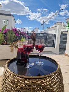 two glasses of wine on a table on a patio at Casa de la Suerte in San Fulgencio