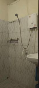 a bathroom with a shower and a sink at Ning Ning hostel Dondet in Don Det