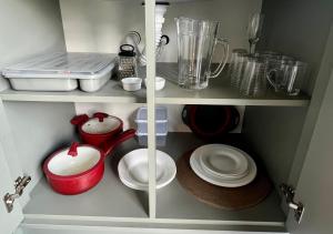 a cupboard filled with dishes and a blender at Éden Bed & Nature in Praia Grande +70 photos