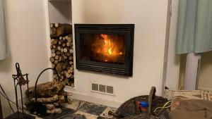 a fireplace in the corner of a living room at Villa-Gaby villa entière et piscine in Menton