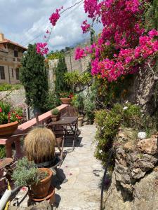a patio with a table and some flowers and plants at Villa-Gaby villa entière et piscine in Menton