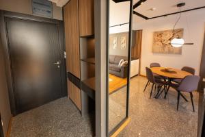 a room with a door and a table and chairs at Modern Mountain - Comfort Apartment in Kolašin