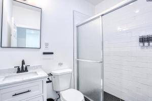 a white bathroom with a toilet and a shower at Newly Built Lake House Near NYC EWR MetLife AD Mall in Passaic +37 photos