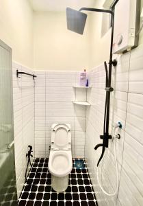 a bathroom with a shower and a toilet in a stall at AZ Roomstay Pendang in Pendang