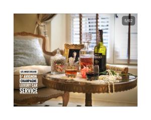 a table with bottles of wine and glasses on it at LES ANGES DELUXE AVIGNON - Exclusive Romantic Home - Private Luxury Tours in Avignon