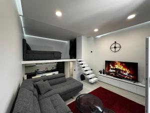 a living room with a couch and a fireplace at Vila Calm in Pogradec