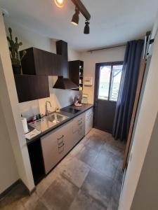 a kitchen with a sink and a counter at Le Cocon de Pinerato in Albi +1 photo