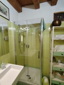 a bathroom with a glass shower and a sink at Mazzini Suite in Verona +28 photos