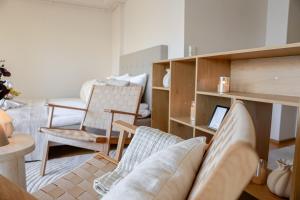 a living room with a couch and chairs and a table at Calm City Studio By BookLapland in Rovaniemi